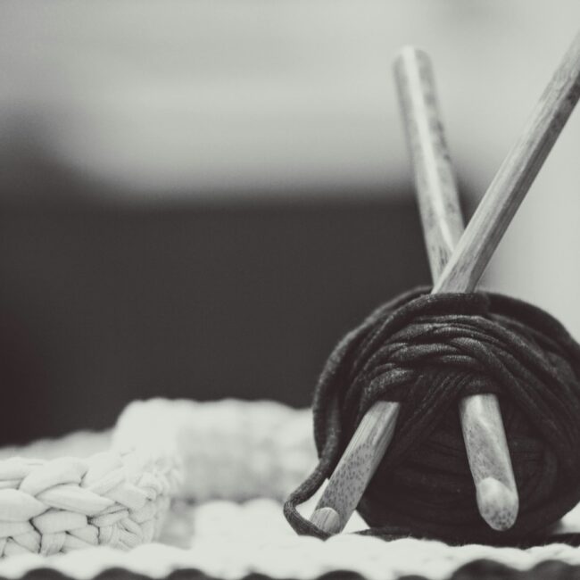 gray wooden sticks with black yarn