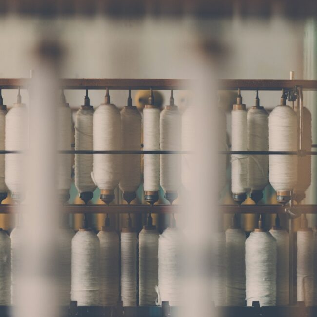 photography of white treadle on brown wooden rack